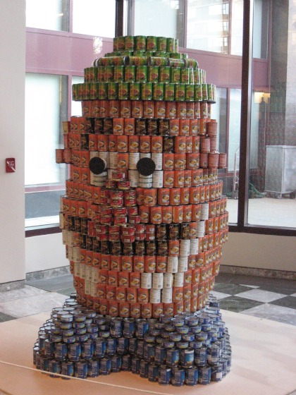 Mr. Potato head made from cans of blue for feet, orange for body and green for hat at the Canstruction 2010 show
