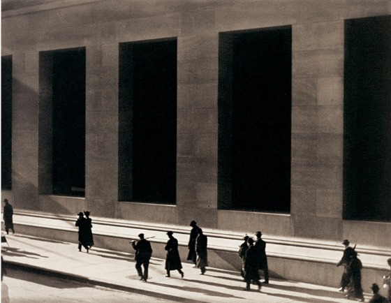 Paul Strand photograph at the Whitney Museum in NYC of men and women in black walking in front of a cement building