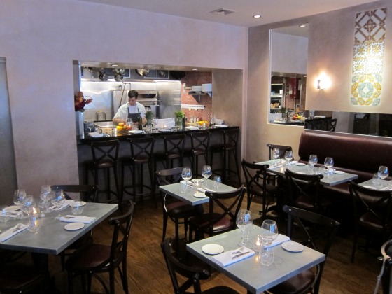 A view of the dining room and kitchen at 83 1/2 Italian restaurant in New York City