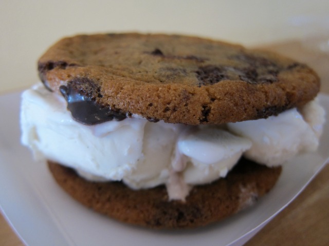 Chocolate chip, hot fudge ChickaLicious Ice cream sandwich with vanilla ice cream.