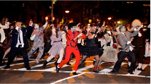 The Halloween Village parade in NYC with people dressed up as zombies and other creatures, dancing to Michael Jackson's Thriller