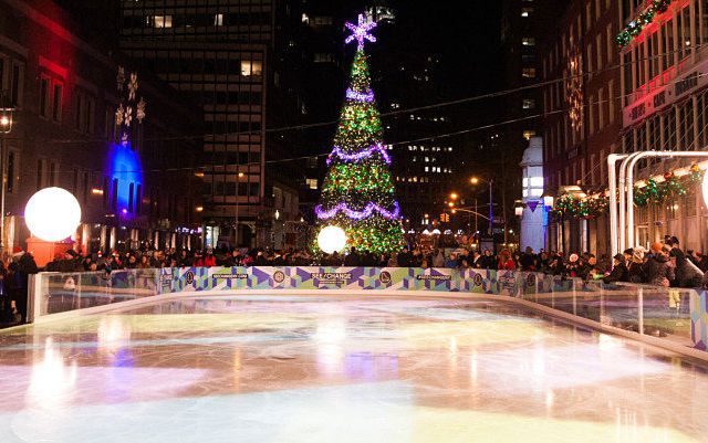Image of the empty ice rink at south street seaport with their christmas tree lit in the background