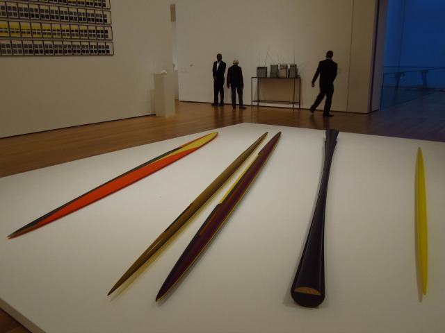 Sitting on a large white surface lies Isa Genzen's giant colorful toothpicks as part of her MoMA exhibition