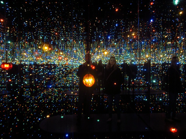 Inside Yayoi Kusama's "souls millions light years away" infinity room are people enjoying the galaxy of lights at David Zwirner Gallery