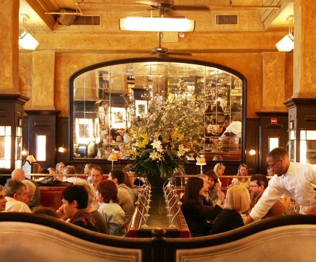 The dining area at Balthazar packed with families and couples eating Christmas dinner in NYC