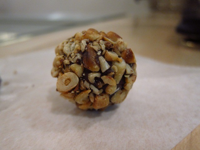 Close up image of Kee's Chocolate truffle covered in nuts