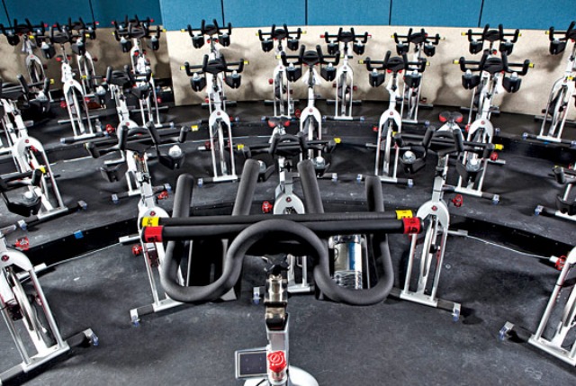 Flywheel's workout classes have stadium seating for their indoor cycling classes so that all attendees can view the instructor