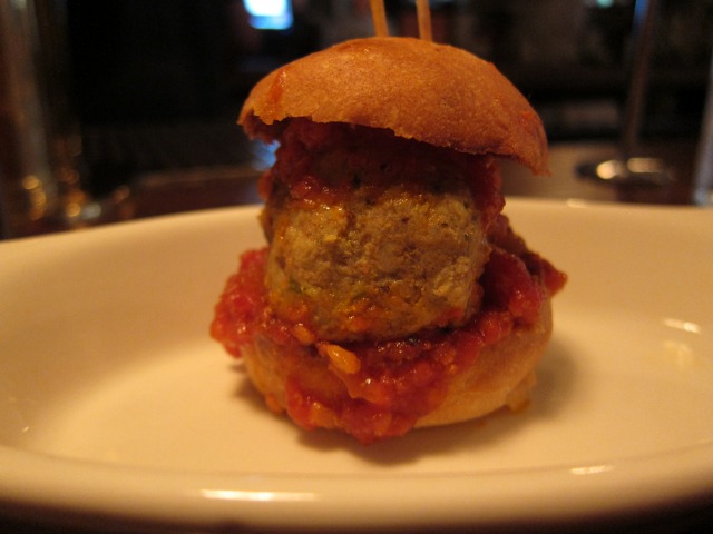 A small hambuger, or "slider," with read sauce at Meatball Shop in NYC for Brunch