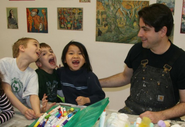 Art instructor at the Upper East Side Art Center working and having fun with three children in his class