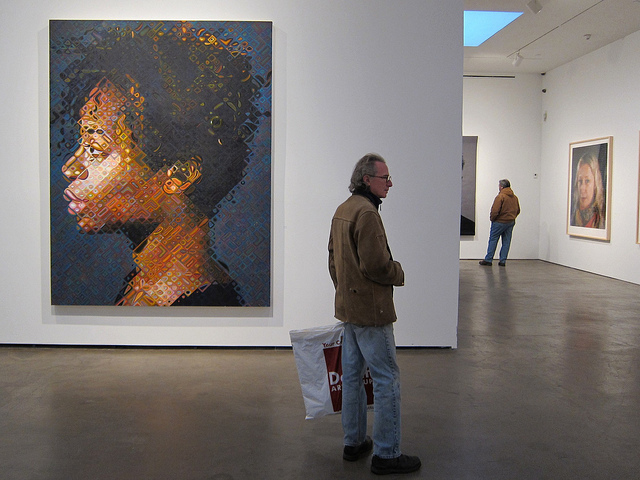 Second Avenue Subway artist Chuck Close's pixelated style mosaic portraits on the wall at an art gallery