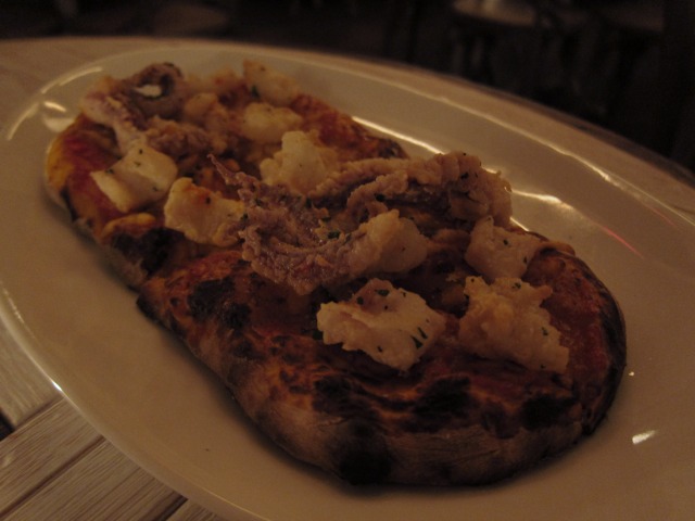 A close-up of the fried calamari sourdough pizza at Tribeca's Telepan Local