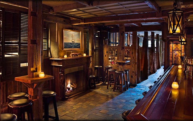 Image of the interior of the Ninth Ward bar in NYC, with a cozy feel and a fireplace to get warm in front of