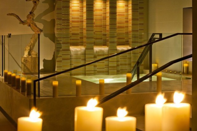 Image of a private hot tub in nyc surrounded by candles and relaxing decor at Setai