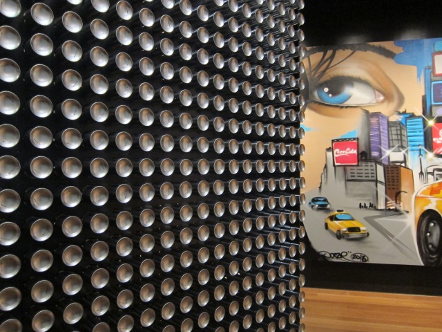 Image of a wall made of soda and beer cans at the Museum of the City of New York