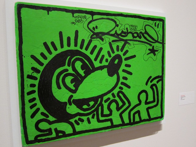A bright green graffiti piece with a cartoon dog on it by famous artist Keith Haring
