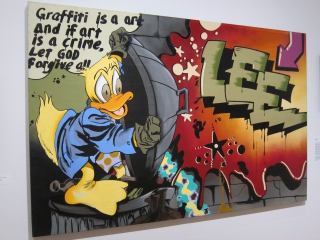 An image of a graffiti piece by famous artist Lee of a cartoon duck with a trash can top, and says "Graffiti is a art and if art is a crime let god forgive all."