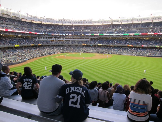 Fans in the stands look out at Yankee Stadium field