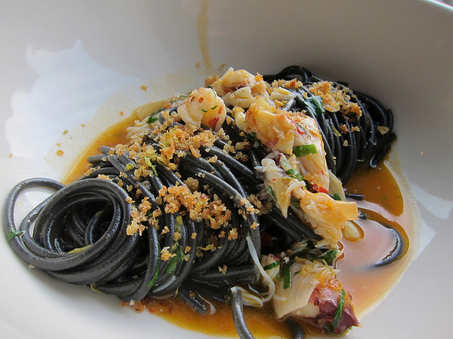 Freshly made spaghetti pasta in green with sauce at Charlie Bird SOHO