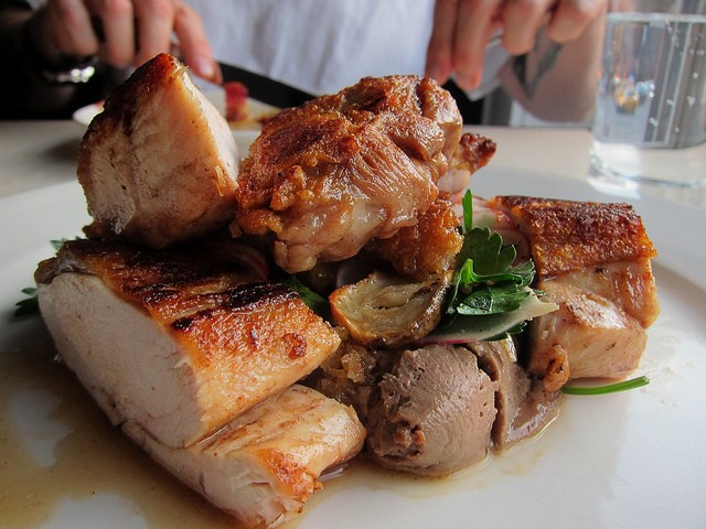 close up of roasted chicken pieces at Charlie Bird in NYC