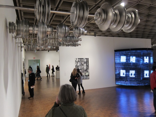 Image of the people walking around, admiring the artwork at the Whitney Biennial
