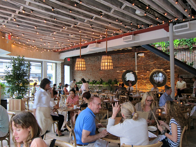 The seating area at Rosemary's filled with people enjoying Easter Brunch in NYC