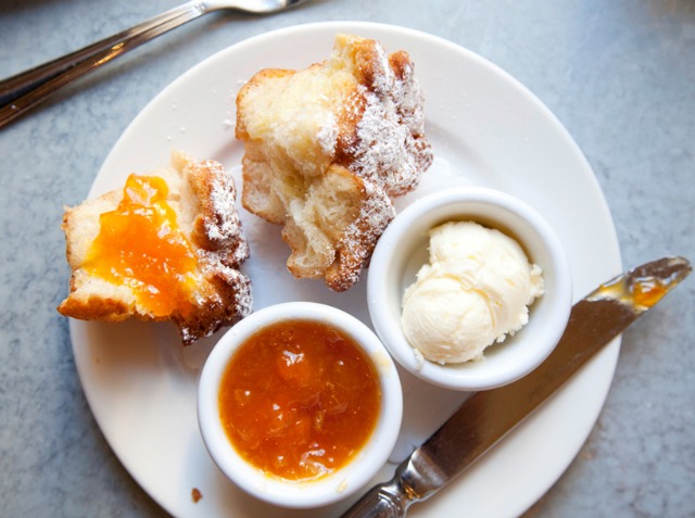 A plate of Coffee cake with a marmalade spread and butter from Sarabeth's brunch menu 