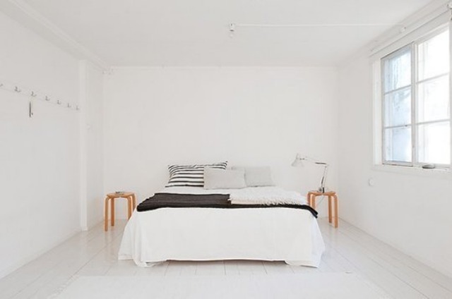 bedroom with white walls and bed, two nightstands