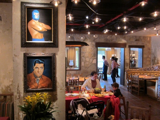 An image of the interior of El Vez with mexican themed portraits and a bright open feeling