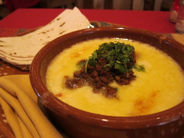 Queso Fundido con Carne, a big bowl of gooey cheese with chorizo to slather onto the soft flour tortillas
