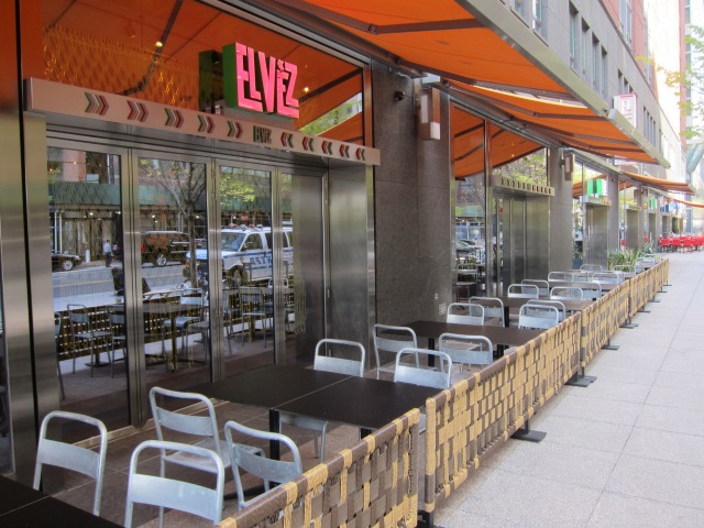 An image of the exterior of El Vez and long row of outdoor seating and tables