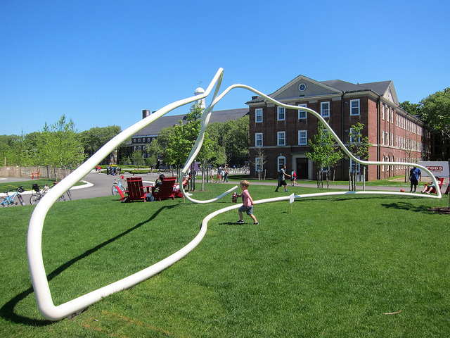 A beautiful, cloudless day on Governors Islands where children play with one of the new gigantic play structures.