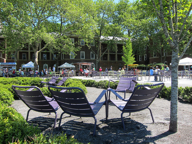 Large seating area filled with trees, lawn chairs, and people enjoying the beautiful weather at Governors Island.