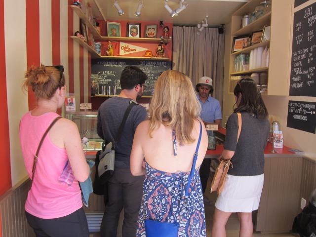 A group of four - one woman and two men wait in line at the East Village's new ice cream parlor, Odd Fellows