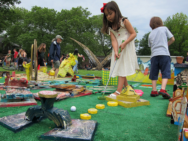 Young girl plays mini golf at the Figment NYC arts festival