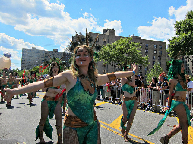 Four women dressed up in green mermaid costumes, walk down the streets for the Mermaid Parade in Coney Island