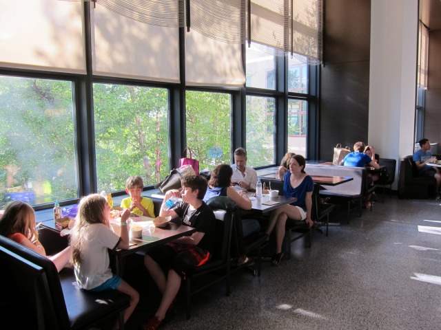 Within the gigantic space that is the Hudson Eats food court, seating is plentiful, including this row packed with people by the window.