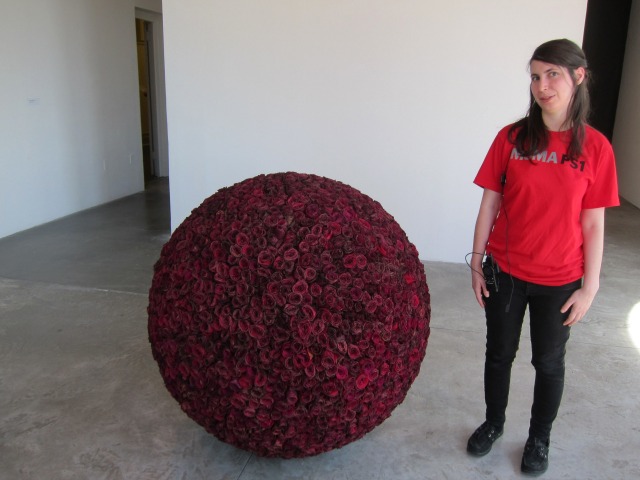 Young women standing in MoMA PS1 next to James Lee Byars' giant rose ball