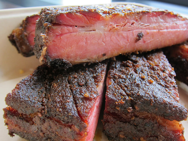 A close-up shot of succulent, charred BBQ from Mighty Quinns BBQ in NYC