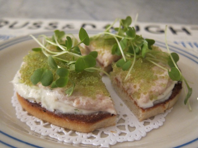 Toasted bagel topped with spread and garnishing from Russ and Daughters Cafe