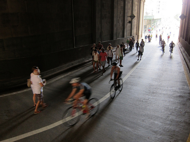 New Yorkers biking and walking inside of a tunnel during NYC's Summer Streets
