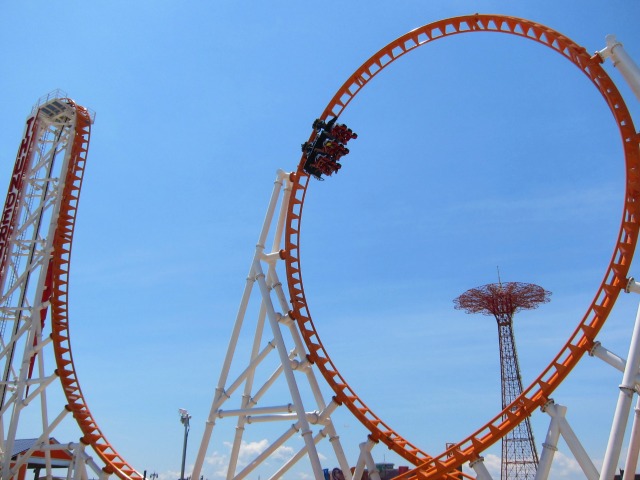 A group of people who just dropped down the major decline of the Thunderbolt rollercoaster only to enter the 100-foot-high loop