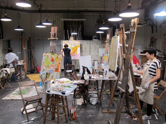  Adult students working on colorful canvases inside the independent art school, Art Students League of New York