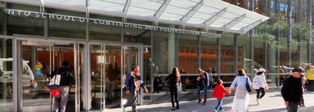 Students and pedestrians walking by the entrance of NYU's School of Continuing and Professional Studies