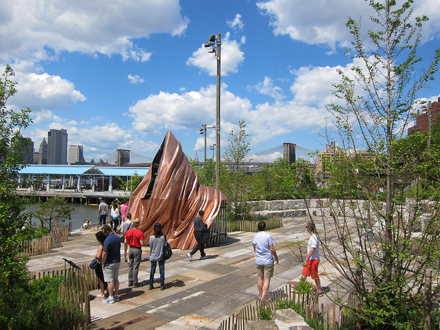 People crowd around the pu.blic art at Pier 3 in NYC called We the People by Dahn Vo