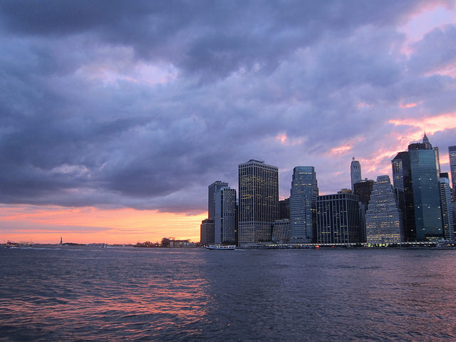 Image taken from the Brooklyn Bridge Park of the downtown Manhattan skyline during a sunset.