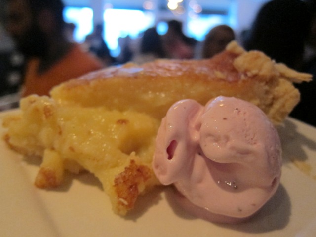 Image of a scoop of pink strawberry ice cream sharing a plat with a slice of buttermilk chess pie.
