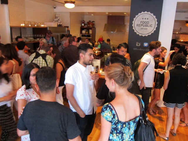 Image of a room full of people walking around and mingling in a NYC event space called Little Owl