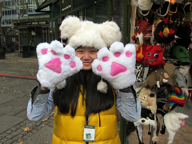 A customer with bear paw gloves shopping at Bryant Park's Winter Villageq