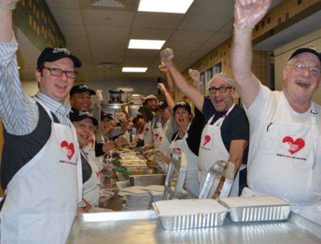 Volunteers celebrating at a Thanksgiving food drive on Thanksgiving