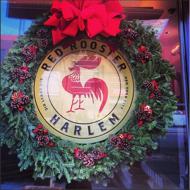 A festive wreath hanging in front of Harlem restaurant Red Rooster.